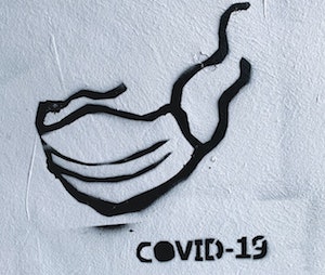 Graffito: Maske und Schriftzug Covid-19